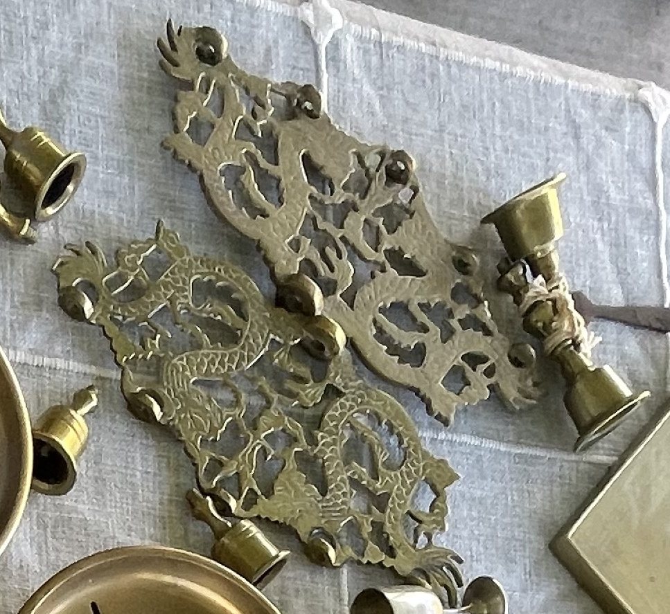 Pair of openwork cast-brass dragon plaques / trivets and a small scroll ornament
